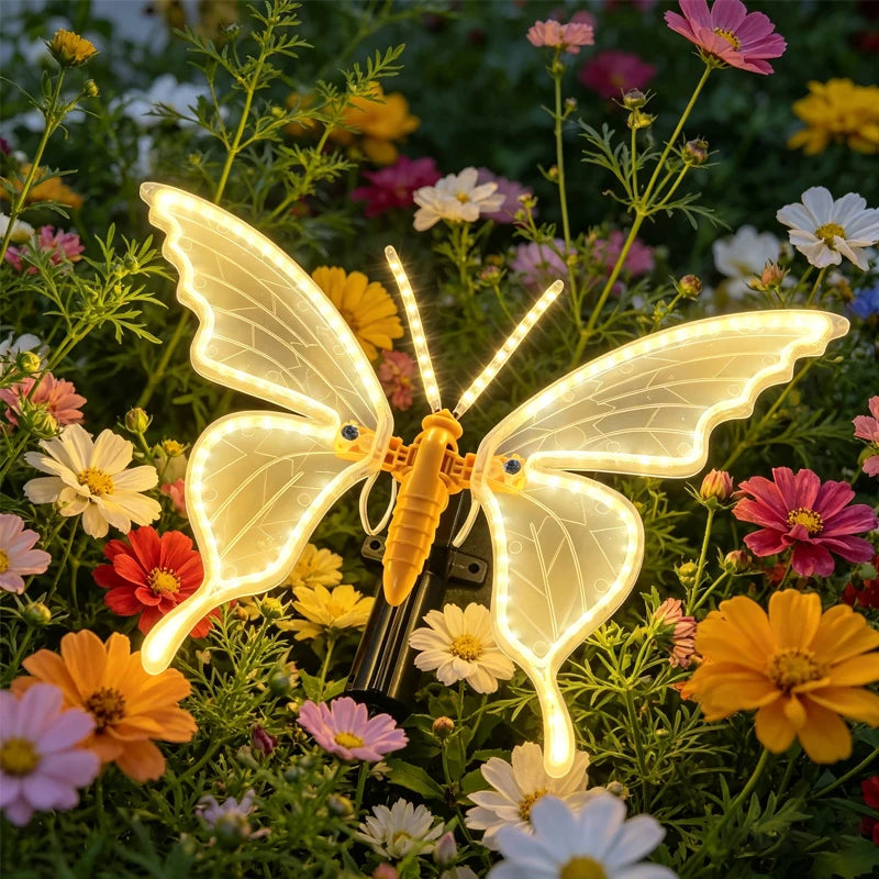 borboleta luminosa de led para jardim entre flores coloridas