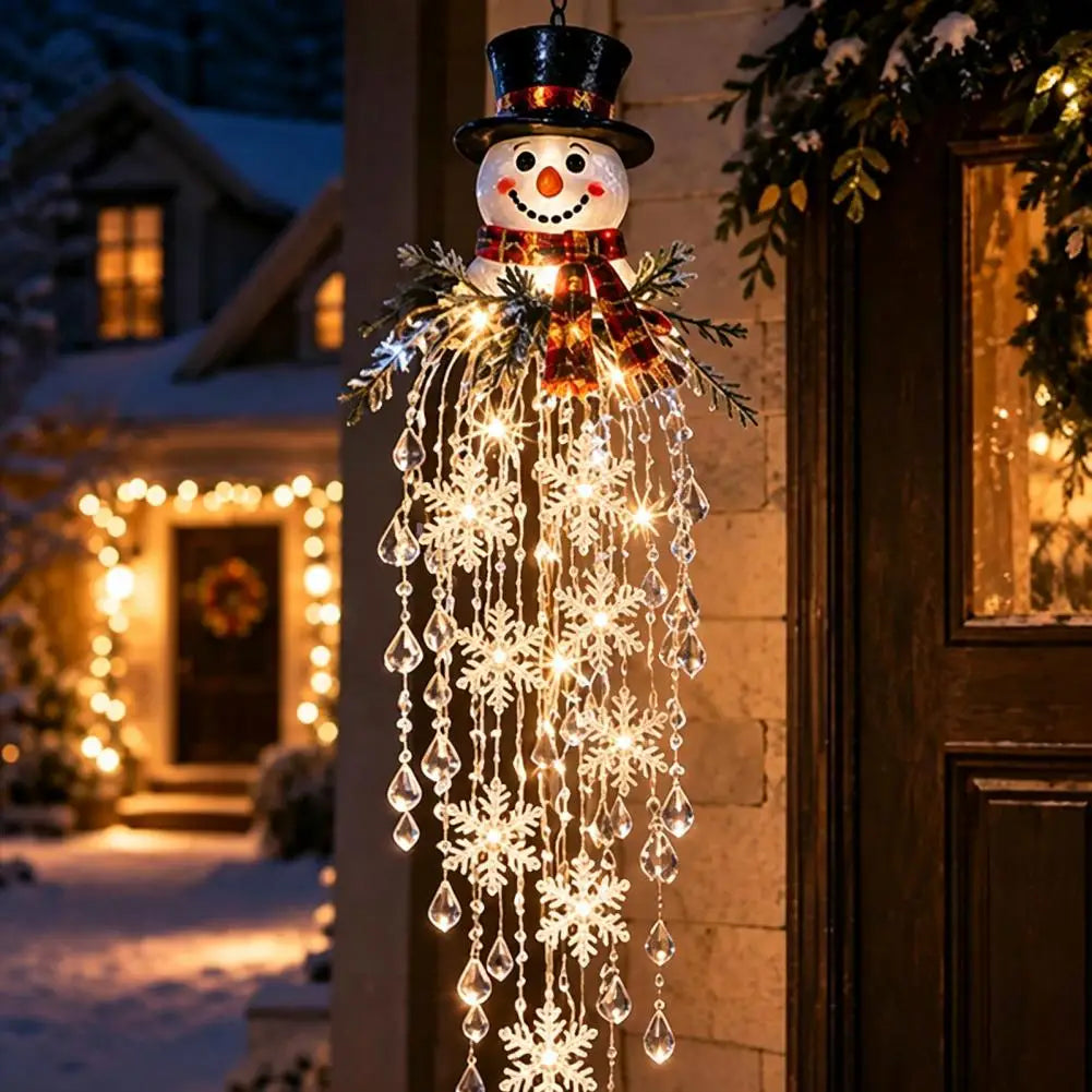 cascata de natal com boneco de neve iluminada na porta