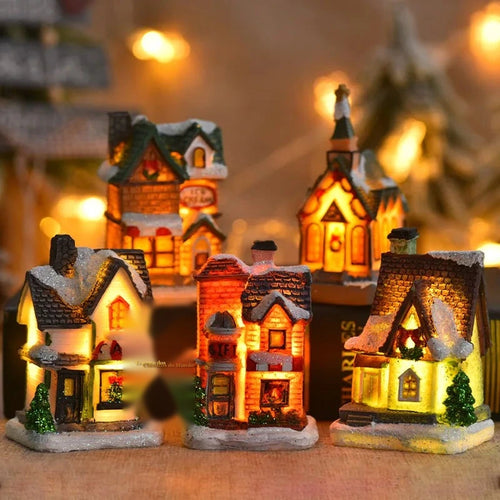 casinhas de natal com led acesas sobre a estante