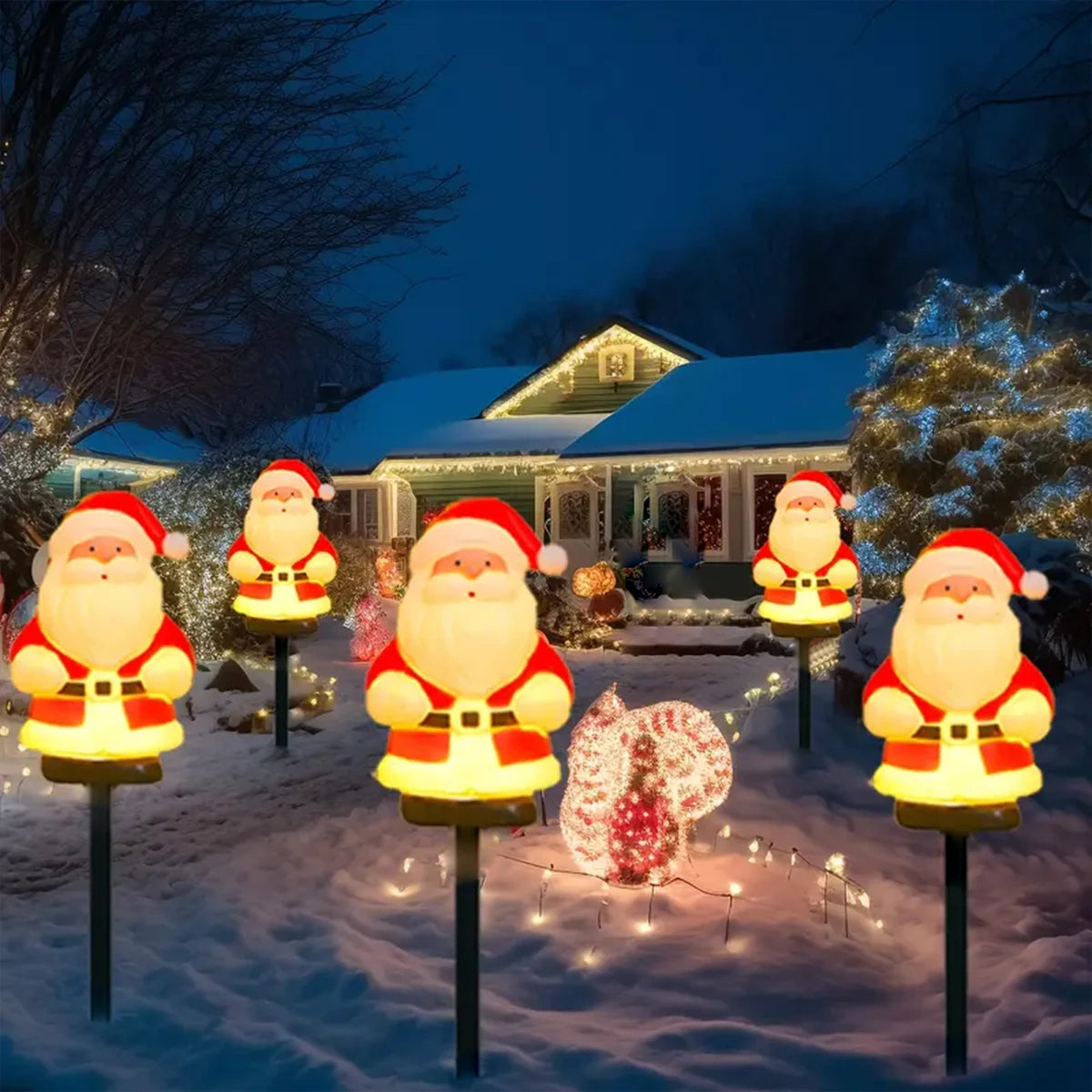 luzes solares de papai noel em estacas no jardim com neve