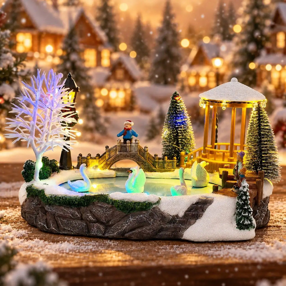 vila de natal iluminada com cisnes sobre mesa de madeira
